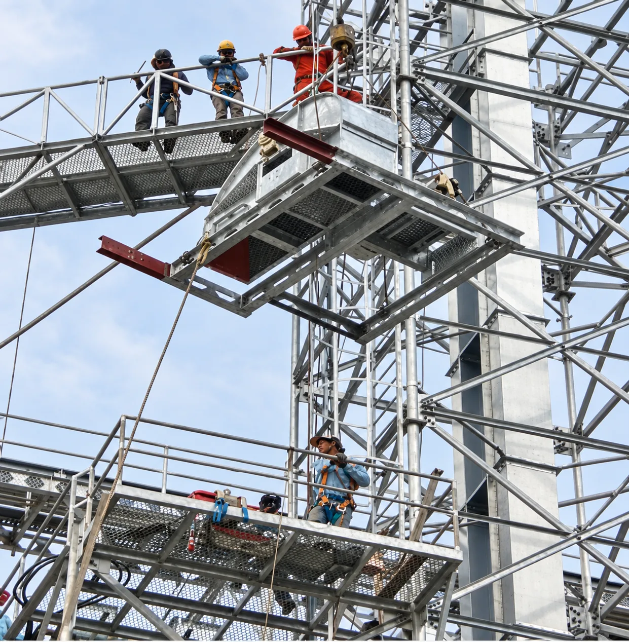 MWT crew installing a bucket elevator, conveyor and supporting steel structure at height